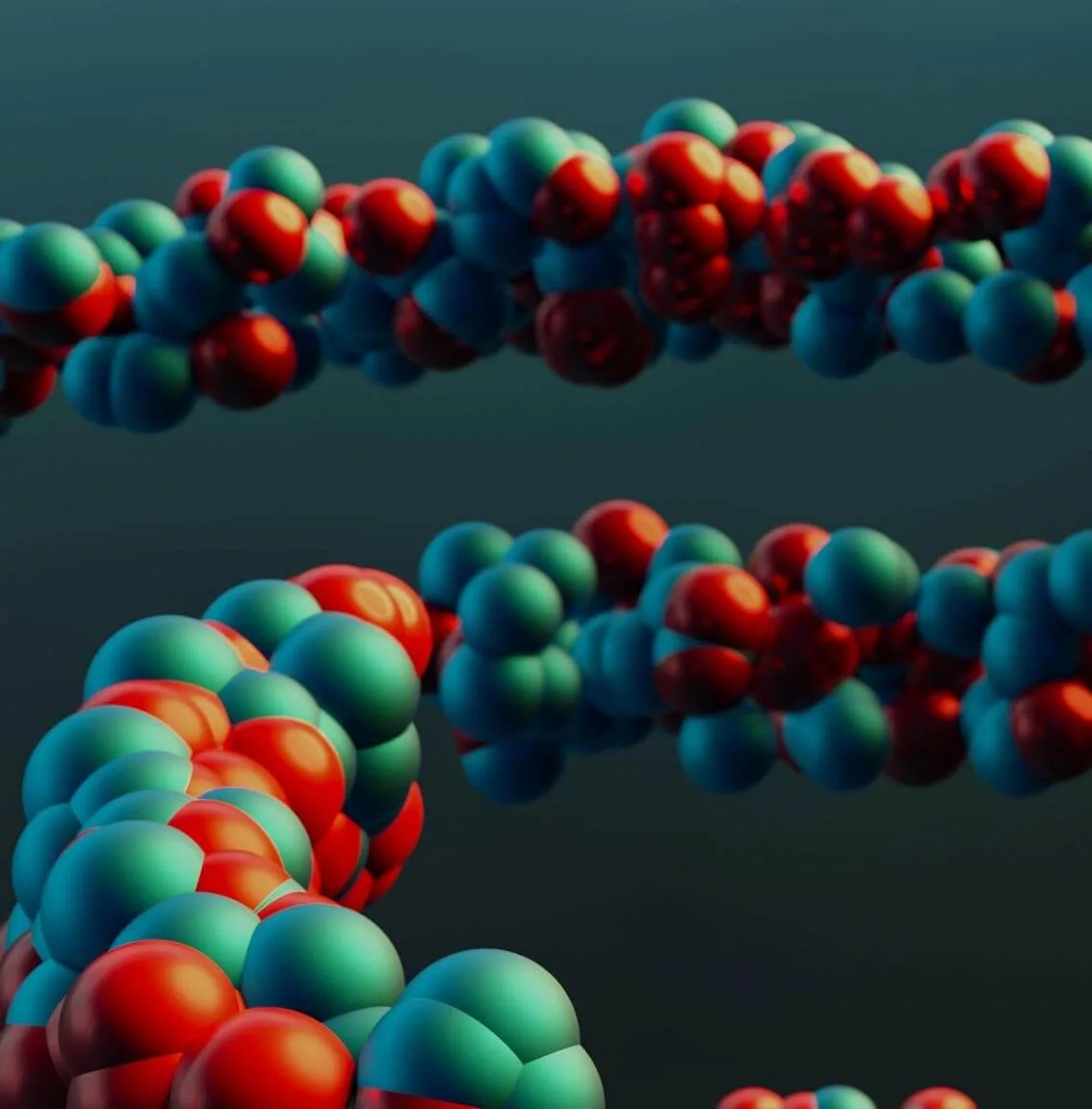 Colorful molecular structures composed of clustered red, teal, and blue spheres, arranged in twisting, chain-like formations against a dark, blurred background.